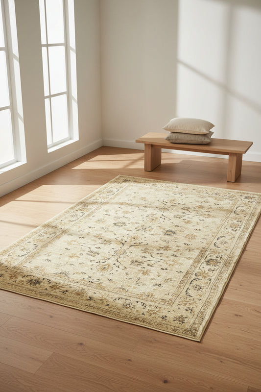A rectangular vintage-style area rug with an ornate floral and medallion pattern in beige, cream, and muted brown tones, shown flat against a white background.