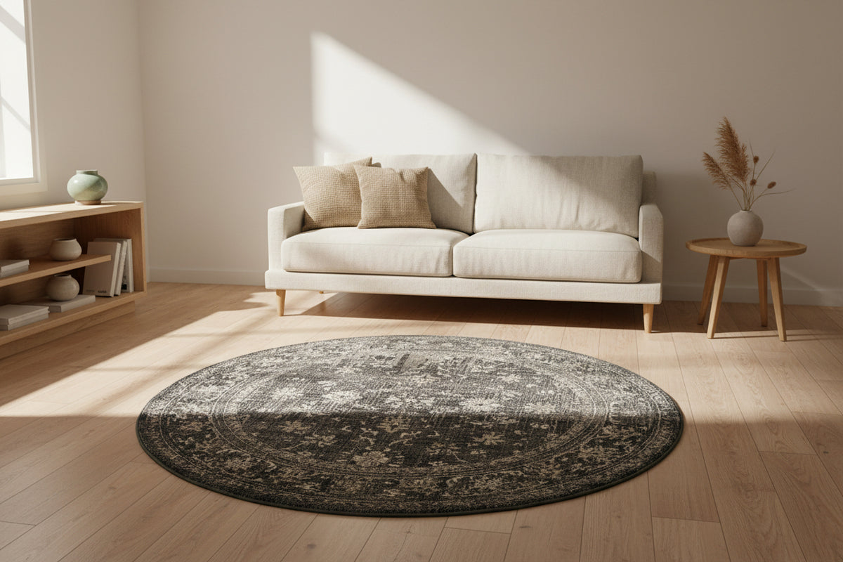 Round rug with intricate black and white pattern on a white background