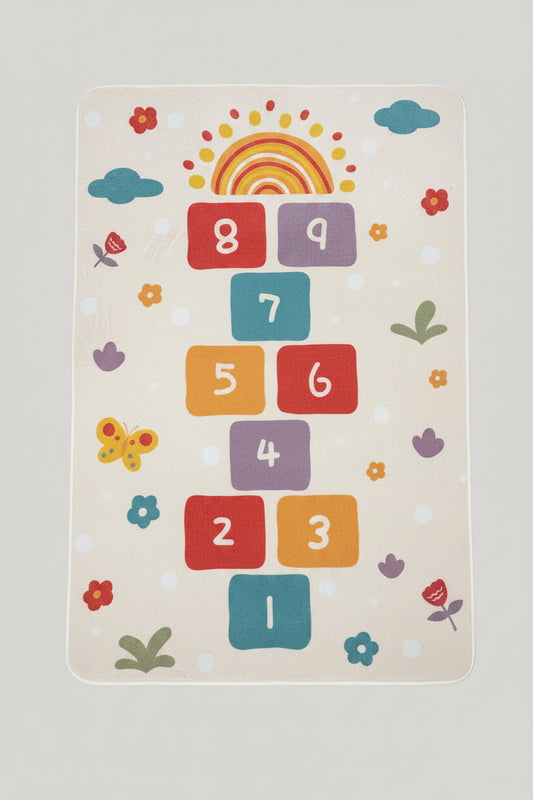 Children's play mat with colorful numbers and shapes on a dark surface