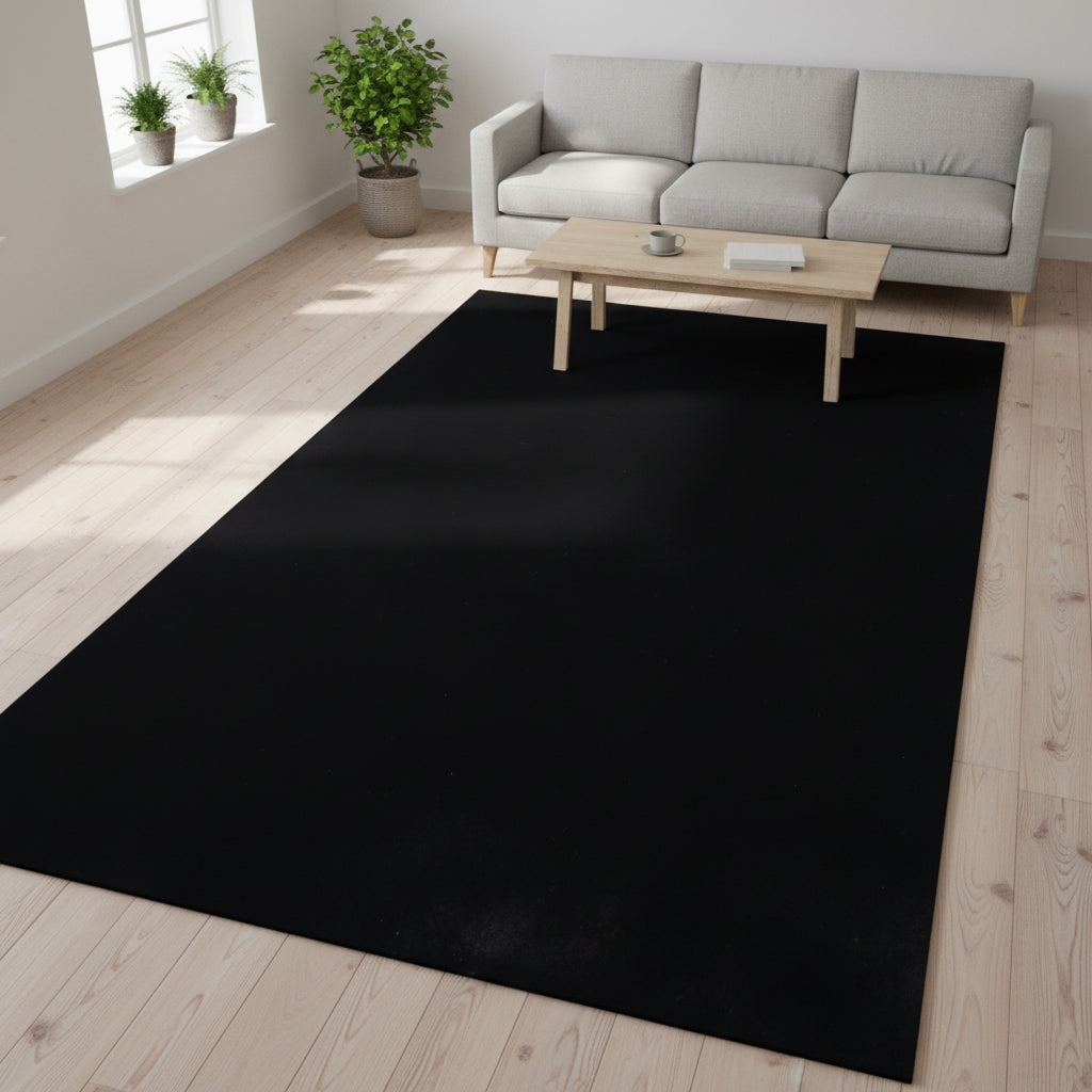 A solid black rectangular mat or rug shown from a top-down perspective on a plain white background.