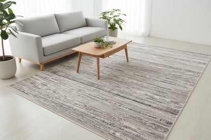 A rectangular area rug with a distressed horizontal stripe pattern in shades of gray, beige, and white, shown from a top-down perspective on a white background.