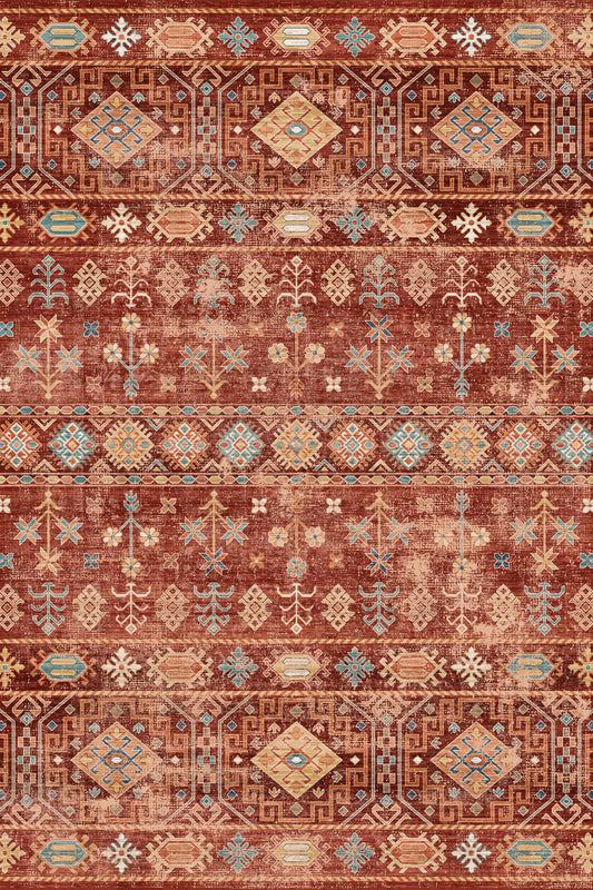 A flat-lay view of a vintage-style area rug featuring a distressed tribal pattern in rust red, terracotta, beige, and light blue.
