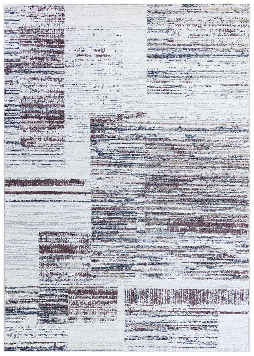 An abstract area rug featuring a distressed geometric pattern with blocks of white, gray, and muted brown.