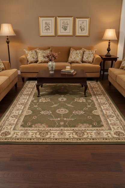 An area rug with an ornate traditional pattern, featuring a dark olive green center field surrounded by beige and brown borders.